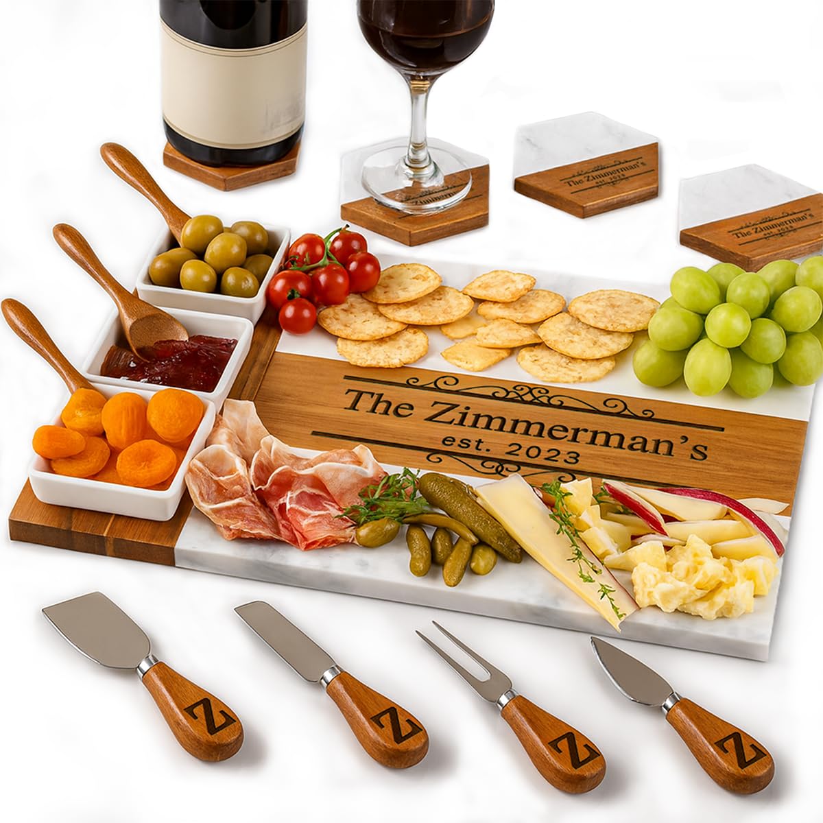 Personalized marble and wood charcuterie board with serving knives and utensils