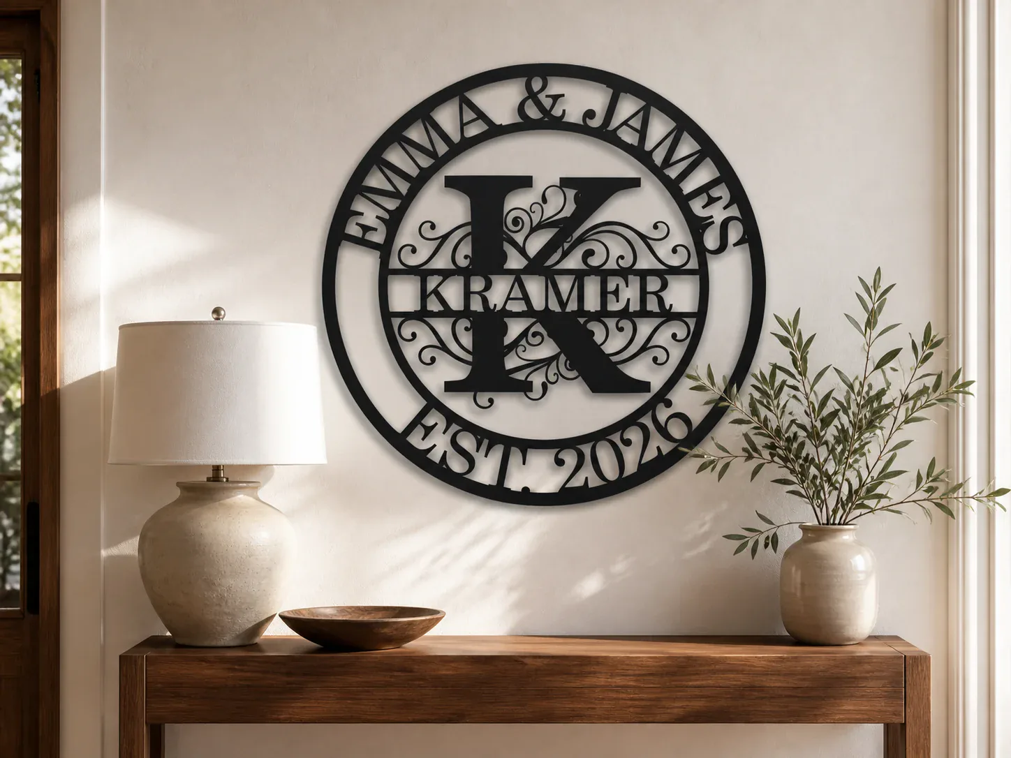 Round black metal sign customized with a family name, initial, and established date
