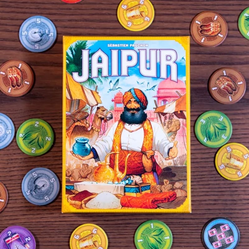 Jaipur two-player board game box surrounded by colorful trade tokens