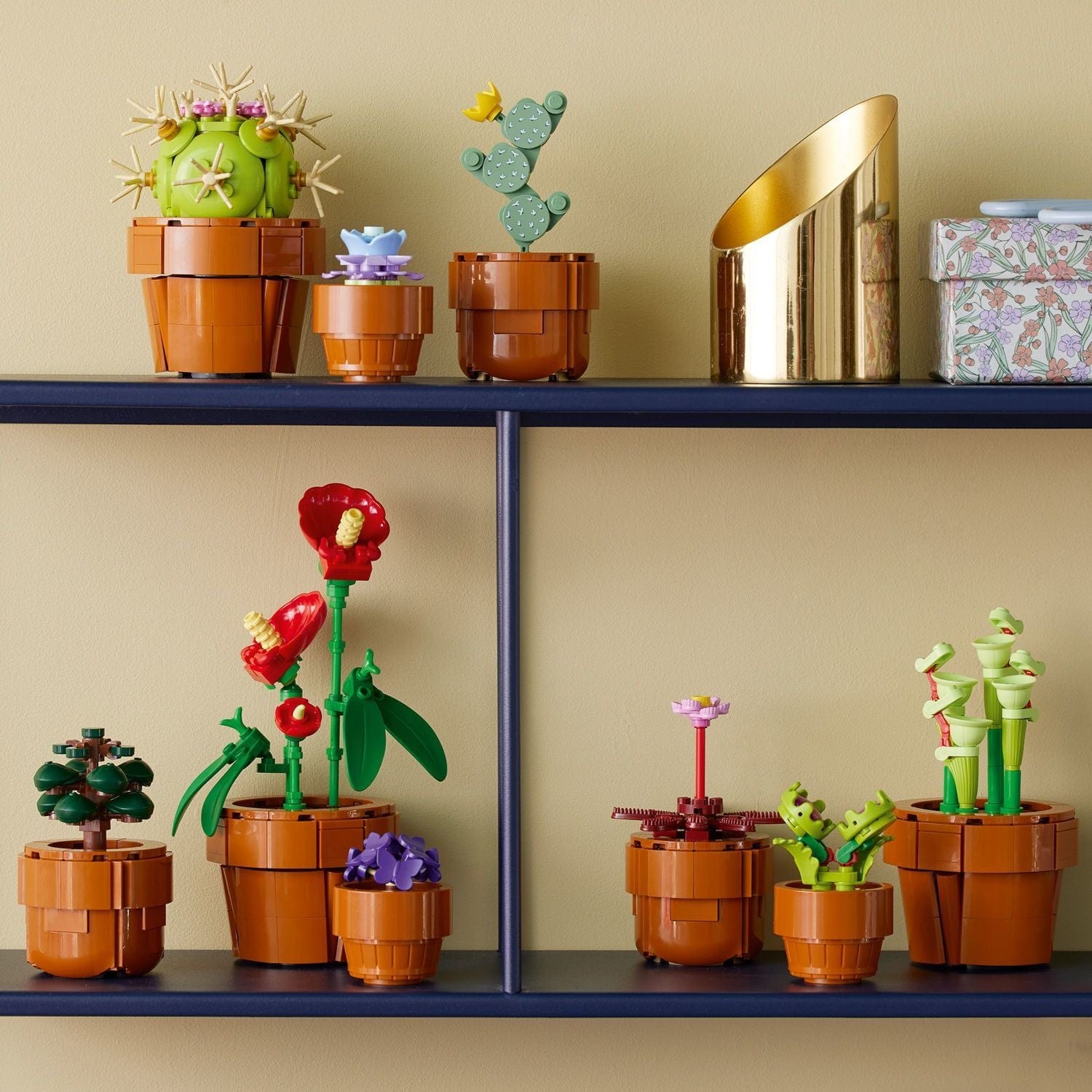 Nine completed LEGO Botanicals Tiny Plants models displayed in small brick-built pots